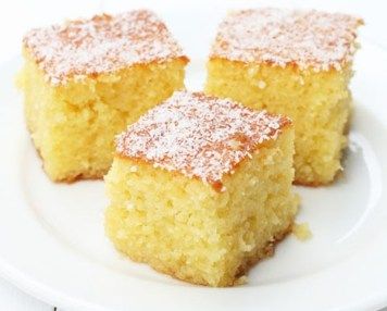 three pieces of cake on a plate with powdered sugar sprinkled on top