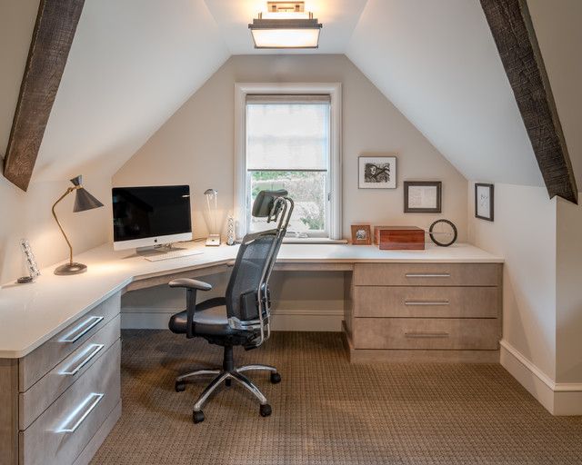 an office with a desk, chair and computer in the atticed room is shown