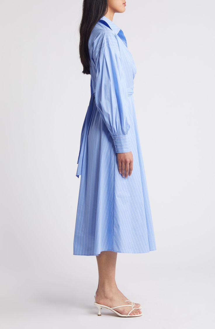 Shirtdress style gets a graceful drape in a cotton-blend midi designed with a wrapped bodice. 47" length (size Medium) Ties at back Spread collar Surplice V-neck Long sleeves with four-button cuffs Partially lined 70% cotton, 27% nylon, 3% spandex Hand wash, dry flat Imported Fitted Cotton Shirt Dress With Tie Waist, Knee-length Cotton Shirt Dress With Tie Waist, Elegant Cotton Midi Dress With Gathered Sleeves, Blue Cotton Midi Dress For Daywear, Long Sleeve Cotton Midi Dress For Office, Cotton Long Sleeve Midi Dress For Office, Summer Shirt Dress With Gathered Sleeves For Work, Chic Fitted Cotton Wrap Dress, Blue Cotton Midi Dress For Formal Occasions