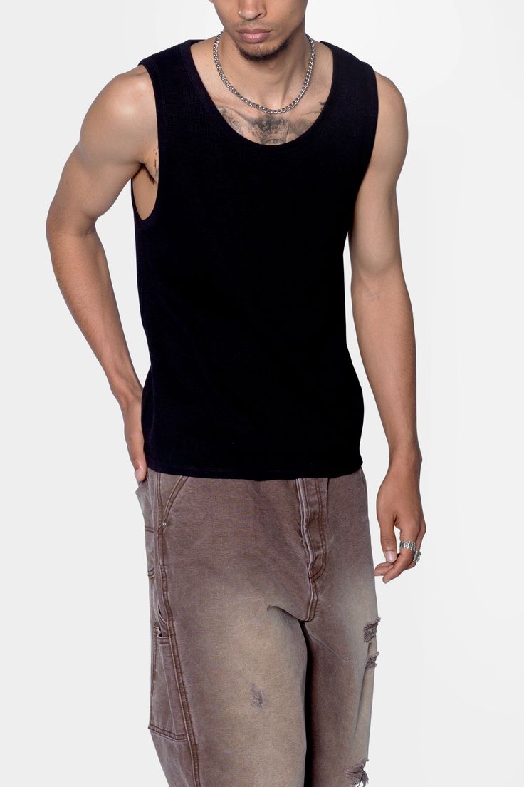 the Waffle Knit Tank is a 100% cotton tank is perfect as a base layer or worn alone. the tank features taping at the neck and arm openings, a flat hem, and is constructed in a ribbed material. details flat hem 100% ribbed cotton fabric Model is 6’0, 140 lbs and wears a size medium Black Tank Top With Ribbed Neckline For Summer, Black Ribbed Neckline Tank Top For Summer, Black Sleeveless Top With Ribbed Neckline, Black Ribbed Cotton Tank Top, Ribbed Cotton Tank Top For Layering, Black Cotton Scoop Neck Vest, Casual Ribbed Vest For Everyday Wear, Casual Everyday Ribbed Vest, Cotton Crew Neck Sweater Vest For Everyday