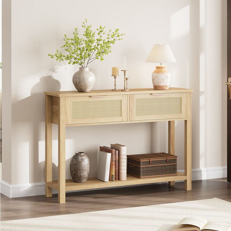 a wooden table with two drawers and some vases on it next to a lamp