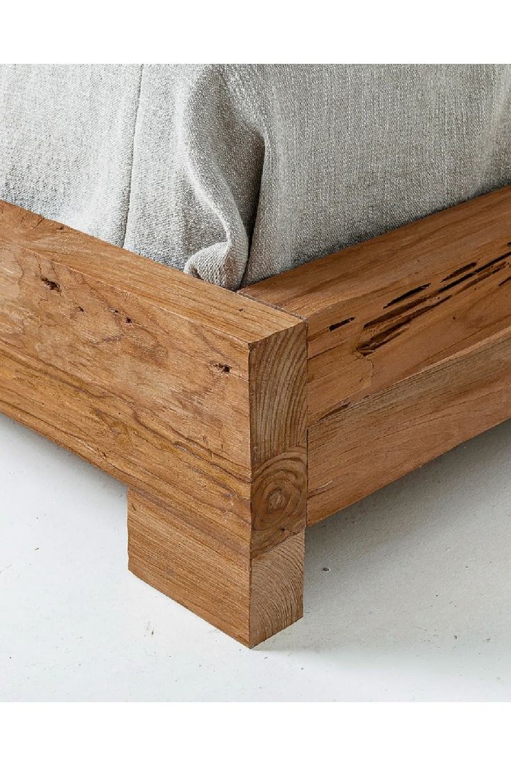 a bed frame made out of wood with no headboard or foot board on it