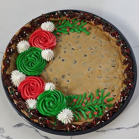 a cake decorated with green, red and white icing