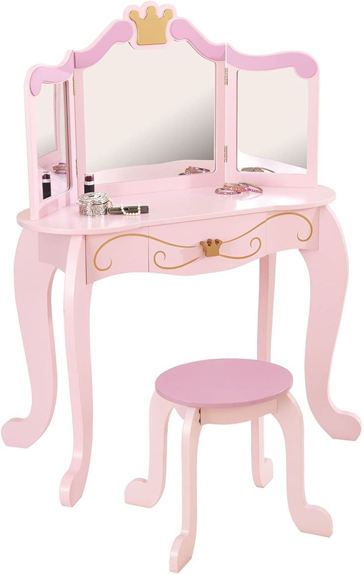 a pink vanity with a mirror and stool