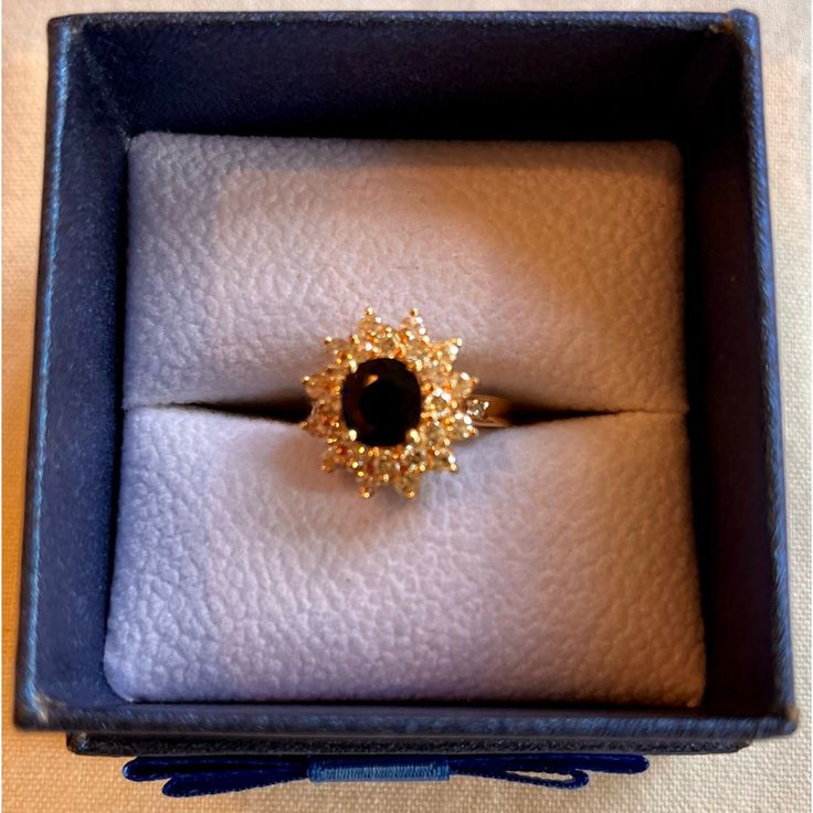 This Stunning 14k Yellow Gold Ring Frames Blue Sapphire Stone With 2 Rows Of Sparkling Diamonds In A Classic “Ballerina” Setting. 12 Smaller Diamonds Encircle The Top Row, Followed By 12 Slightly Larger Stones Encircling Bottom Row. 2 More Diamonds Are Set On Top Right And Left Side Of Band, As Shown In Photo #11, For A Total Of 28 Diamonds. Total Weight Of Diamonds Is Approximately 1k. Total Weight Of Single Sapphire Stone Is Approximately 1k. Total Weight Of Ring Is 6.04 G. Ring Is Size 7. Rin Exquisite Yellow Gold Cluster Ring For Formal Occasions, Luxury Sapphire Rings For Evening, Exquisite Formal Yellow Gold Cluster Ring, Elegant 14k Gold Diamond Ring For Evening, Exquisite Cluster Rings For Formal Occasions, Elegant Sapphire Rings For Evening, Exquisite Formal Cluster Rings, Elegant Evening Sapphire Rings, Cluster Yellow Gold Sapphire Ring