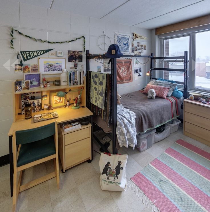 a bedroom with a bed, desk and window