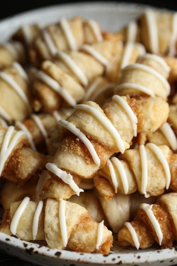 a white plate topped with lots of donuts covered in icing