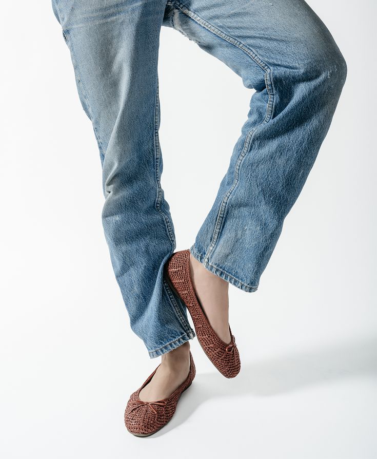 Crafted of hand-knit raffia topped with a premium leather bow, this brown round-toe ballet flat is breathable and lightweight. This silhouette was created with our Barefoot Ballerina technology, which includes a completely flexible leather-lined footbed that bends with you as if you are barefoot, but still offers full arch support and seven layers of cloud-like comfort. The flat is complete with our signature grosgrain backtab and gold Birdies logo. | The Hummingbird - Walnut Raffia Birdies Flats Brown Slip-on Ballet Flats With Flat Heel, Casual Woven Leather Flats With Round Toe, Brown Slip-on Ballet Flats For Spring, Casual Ballet Flats With Leather Sole For Fall, Casual Brown Ballet Flats For Spring, Casual Brown Closed Toe Ballet Flats, Brown Rubber Sole Ballet Flats For Spring, Spring Casual Ballet Flats With Woven Sole, Brown Slip-on Ballet Flats With Rubber Sole