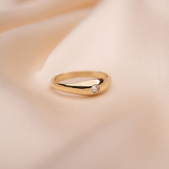 a gold ring with a diamond on it