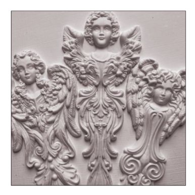 an intricately carved wall panel with angels and cherubs on the sides, in white