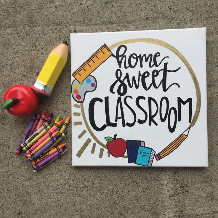 a sign that says home sweet classroom next to some crayons and pencils