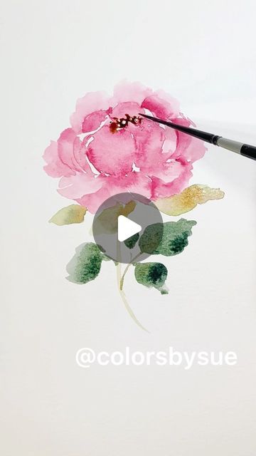 someone is painting a flower with watercolors