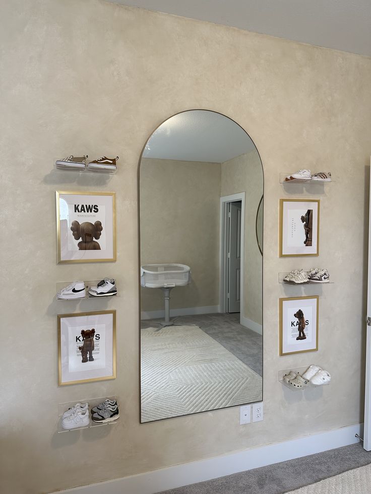 a mirror that is on the side of a wall with pictures and words above it