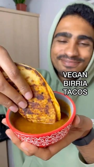 a man holding a bowl filled with food