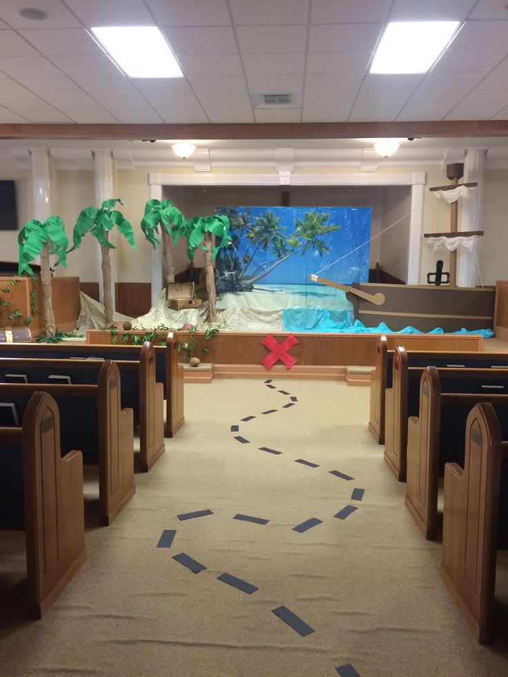 an empty church with pews and palm trees in the background, on a carpeted floor