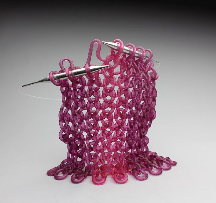 an object made out of pink beads and scissors