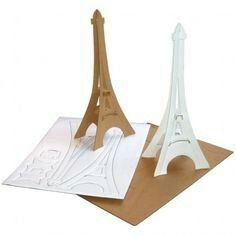 two paper models of the eiffel tower on top of a piece of cardboard