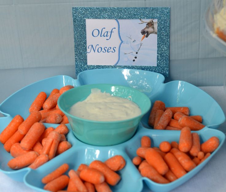 carrots and dip are arranged in bowls on a tray