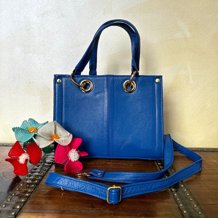 MADE IN MEXICO No doubt about it you will stand out with this gorgeous one of kind 100% authentic leather bag For: Women Color: blue | multi Dimensions: 12 x 9 x 4.5 Details: 100% Authentic Leather Style: Top-handle bag Front Embroidered Design Handle Straps: 7" Drop Adjustable & removable strap: 22" Removable claw clasp tassel 2 inner compartments Snap button closure Fabric linen Flat Bottom Side studs Button stud Gold Hardware FOR MORE DETAILS PLEASE CONTACT US. PLEASE READ BEFORE PURCHASE: Th On-the-go Blue Rectangular Satchel, Blue Rectangular Shoulder Bag With Top Carry Handle, Blue Top Handle Box Bag, Blue Top Handle Shoulder Bag For On-the-go, Blue Handheld Box Bag With Detachable Handle, Blue Satchel Box Bag With Top Carry Handle, Blue Crossbody Box Bag With Adjustable Strap, Blue Handheld Shoulder Bag For Everyday, Blue Rectangular Satchel With Removable Pouch