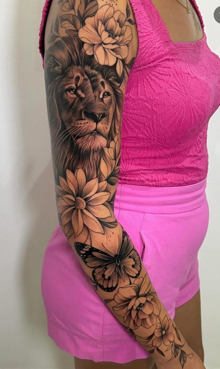 a woman with a lion and flowers tattoo on her arm