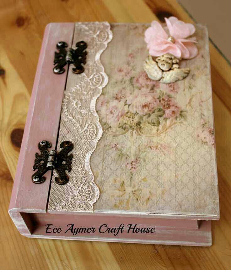 an old pink box with lace and flowers on the inside is sitting on a wooden table