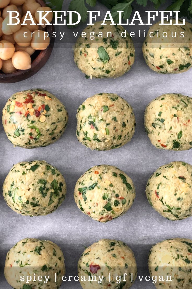 baked falafels with spinach and chickpeas on a baking sheet