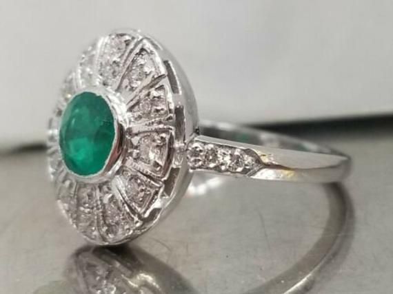 Vintage natural emerald in 14k white gold ring circ 1940's center natural green emerald in round shape weight 0.92ct SIZE 5.8mm side set natural diamonds weight 0.50ct H-SI1 lively,sparkly stone.clean. Ring size 6.5 This tremendous old vintage ring is in a very good condition. Appraisal available Retail value $4,750 net Vintage Green Emerald Ring Gia Certified, Art Deco Round Emerald Ring With Center Stone, Classic Green Diamond Round Ring, Classic Round Green Diamond Ring, Classic Green Diamond Ring, Classic Round Emerald Ring With Halo Setting, Gia Certified Green Diamond Ring In Vintage Style, Platinum Emerald Ring With Center Stone, Gia Certified Green Diamond Round Ring