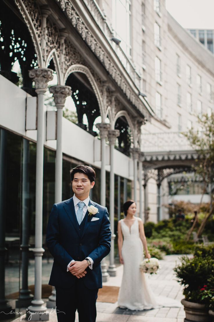 a man in a suit standing next to a woman