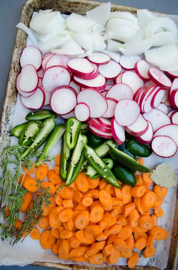 carrots, cucumbers, and radishes laid out on a tray