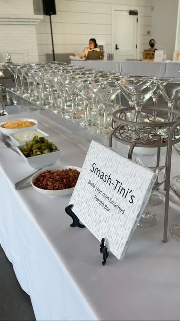 a table topped with lots of different types of food and wine glasses on top of it