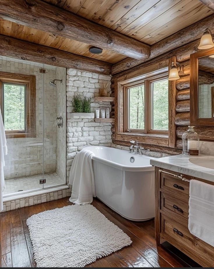 a bathroom with a tub, sink and shower in it's rustic cabin style home