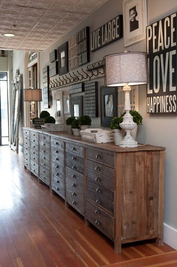 a large wooden dresser sitting inside of a living room