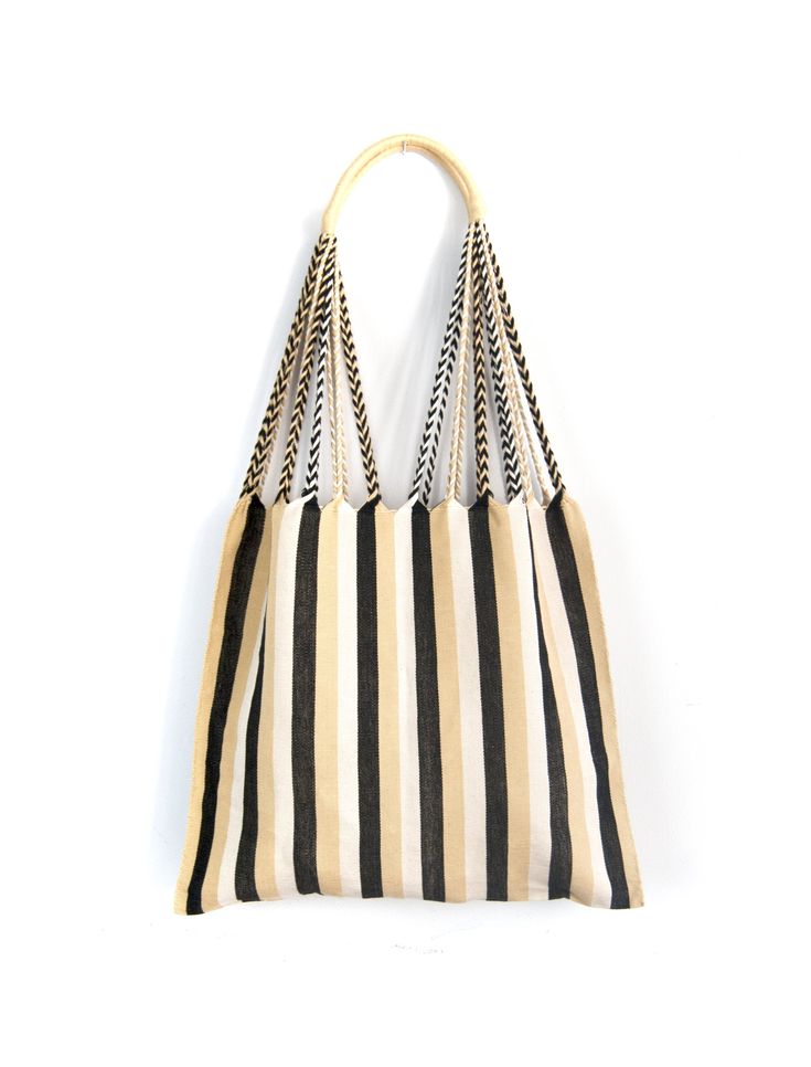 a black and white striped handbag hanging on the wall with chain handles, in front of a white background