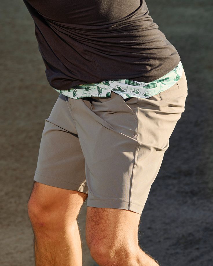 a man in shorts is holding a tennis racquet on the court with his right foot