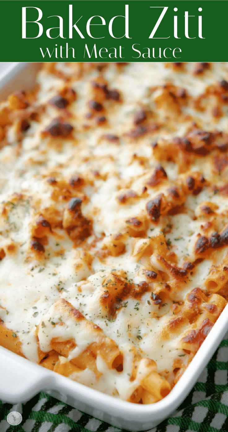 baked ziti with meat sauce in a casserole dish on a green and white checkered cloth