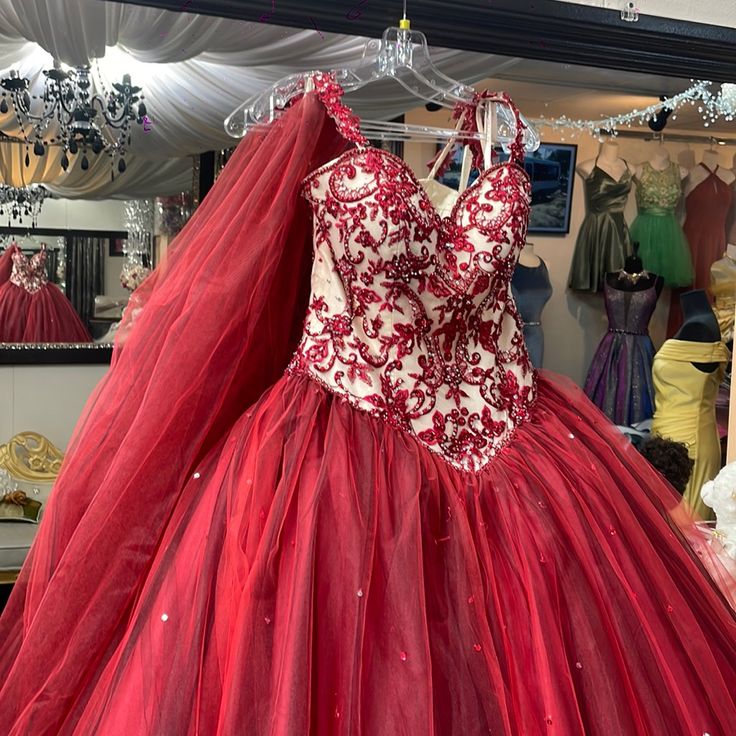 a red and white dress on display in a store