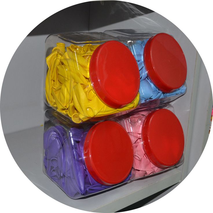 three plastic containers filled with different colored lids