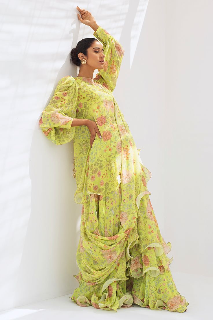 Leena (A) – Sania Maskatiya International Green Traditional Drape Dress For Spring, Green Spring Dress With Traditional Drape, Bollywood Style Pista Green Dress For Spring, Pista Green Bollywood Dress For Spring, Green Saree Dress For Spring, Green Ruffled Sets With Traditional Drape, Traditional Silk Sharara For Spring, Georgette Dress With Digital Print For Designer Wear, Green Ruffled Sharara With Traditional Drape