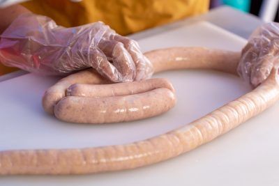 two sausages wrapped in plastic sitting on top of a counter