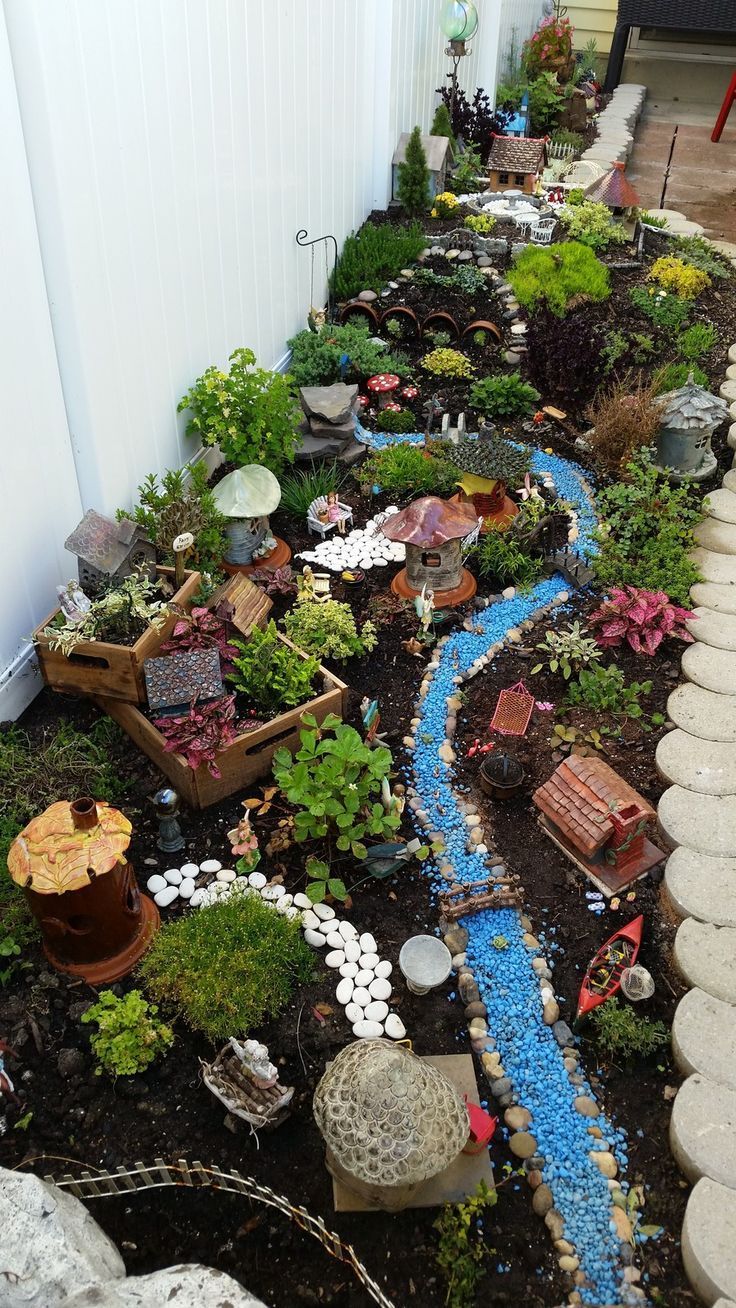 a small garden is shown in the middle of an outdoor area with rocks and plants