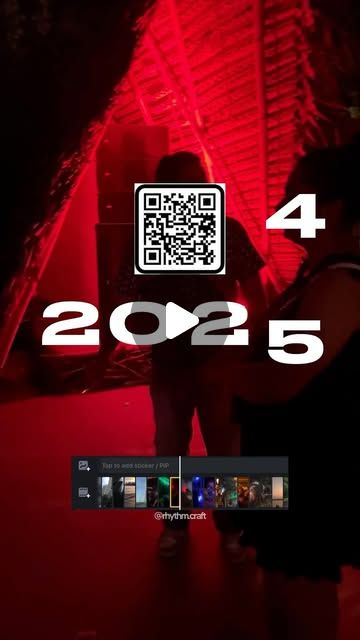 a person standing in front of a red light with qr code on the screen