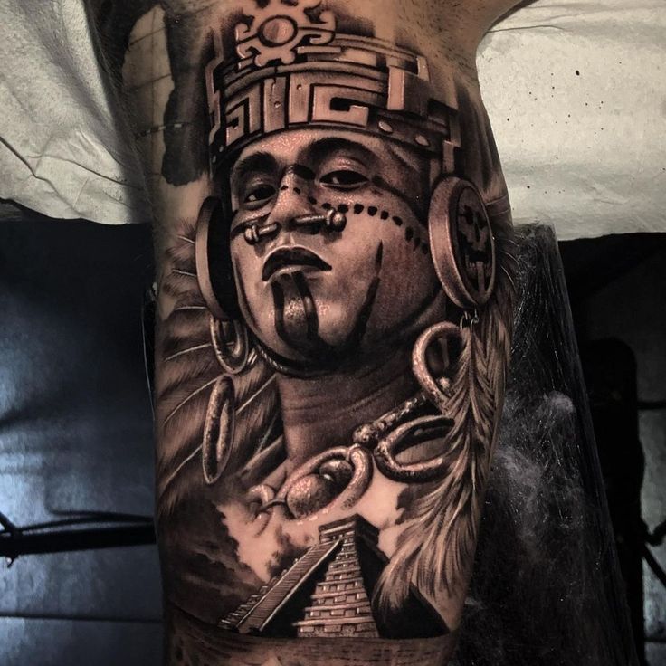 a man's leg with tattoos on it and an image of a native american chief