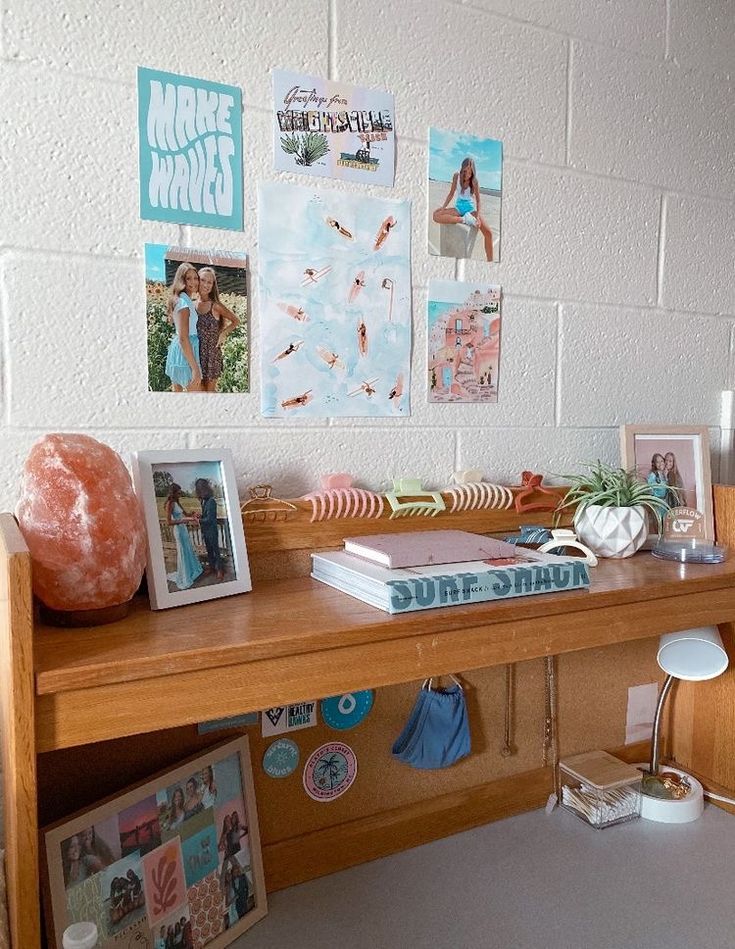 a wooden desk topped with pictures and other items