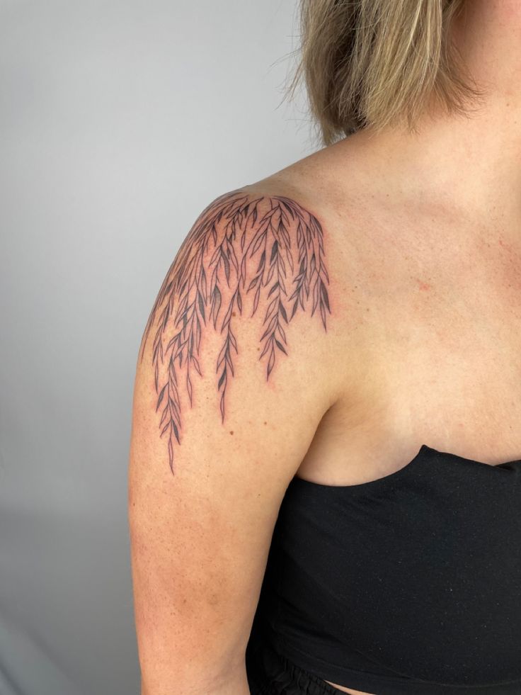 a woman with a tattoo on her shoulder