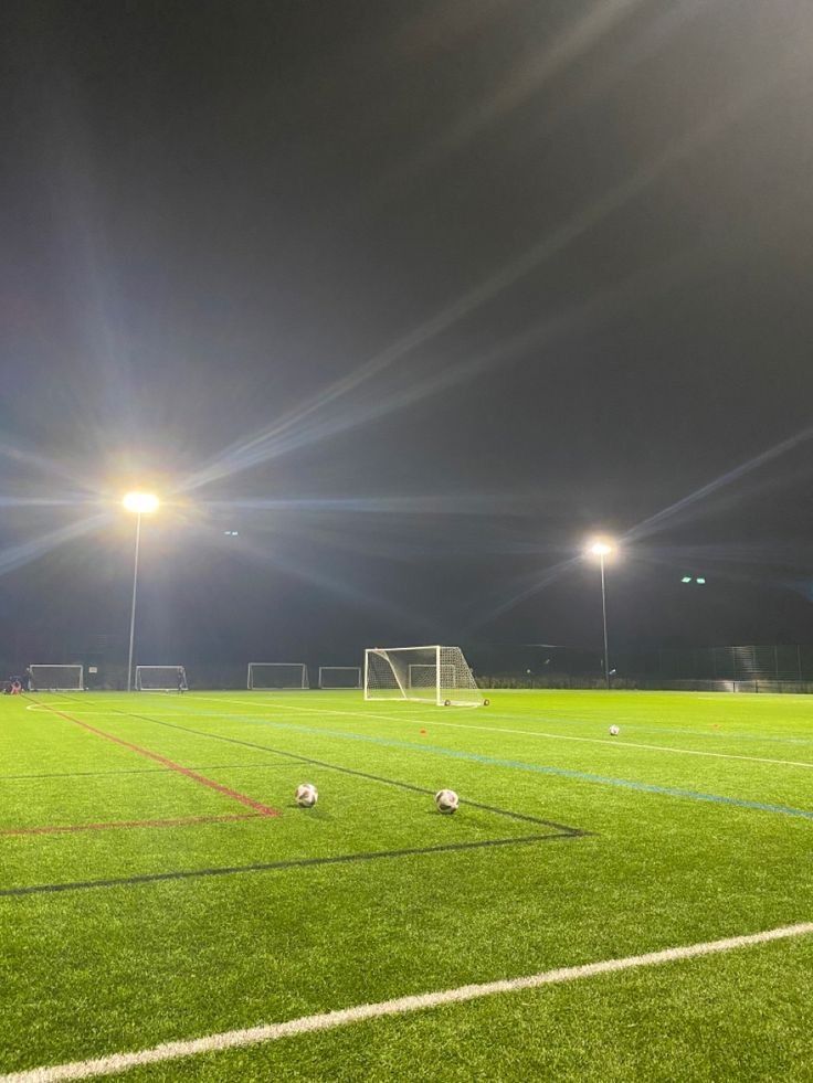 soccer field at night with lights shining on it