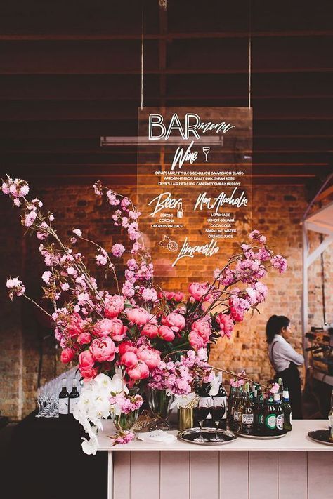 a bar with flowers and bottles on the counter