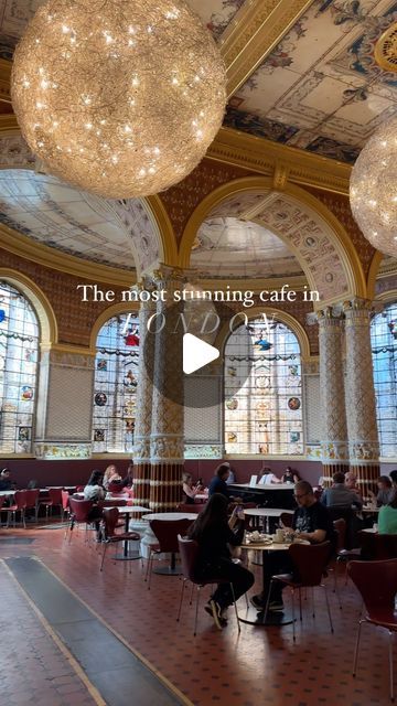 the inside of a restaurant with chandeliers hanging from the ceiling and people sitting at tables