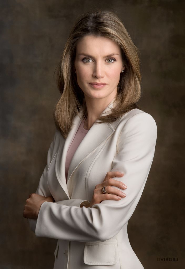 a woman with her arms crossed posing for a photo