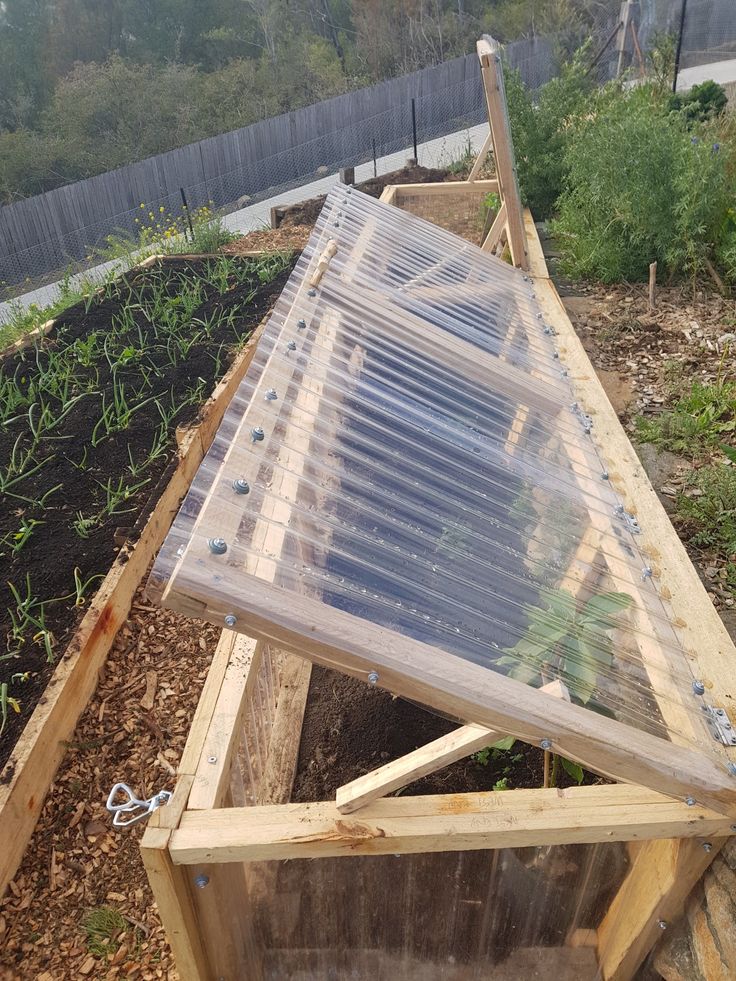 a wooden structure with plastic covering on top of it