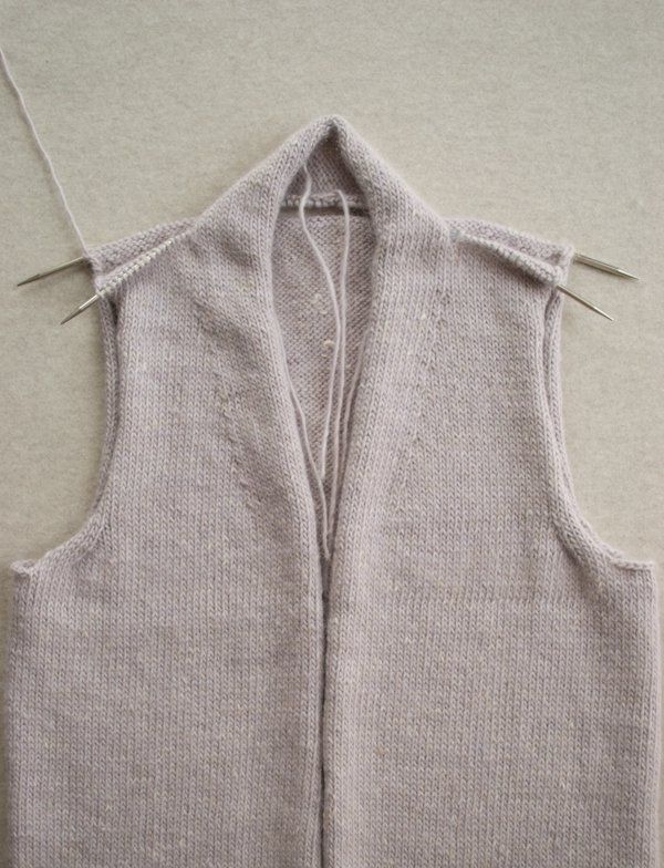 the back of a sweater vest that has been stitched together